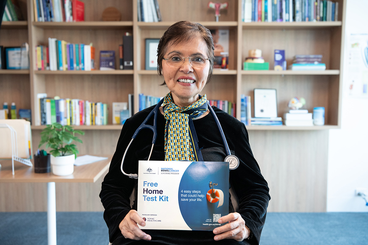 Dr Nguyet Thai holding the bowel screening kit